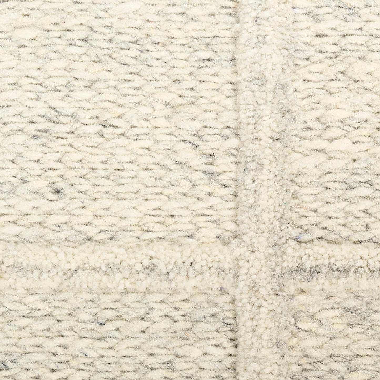 Cream chunky-knit wool blanket with thick woven texture and central seam.