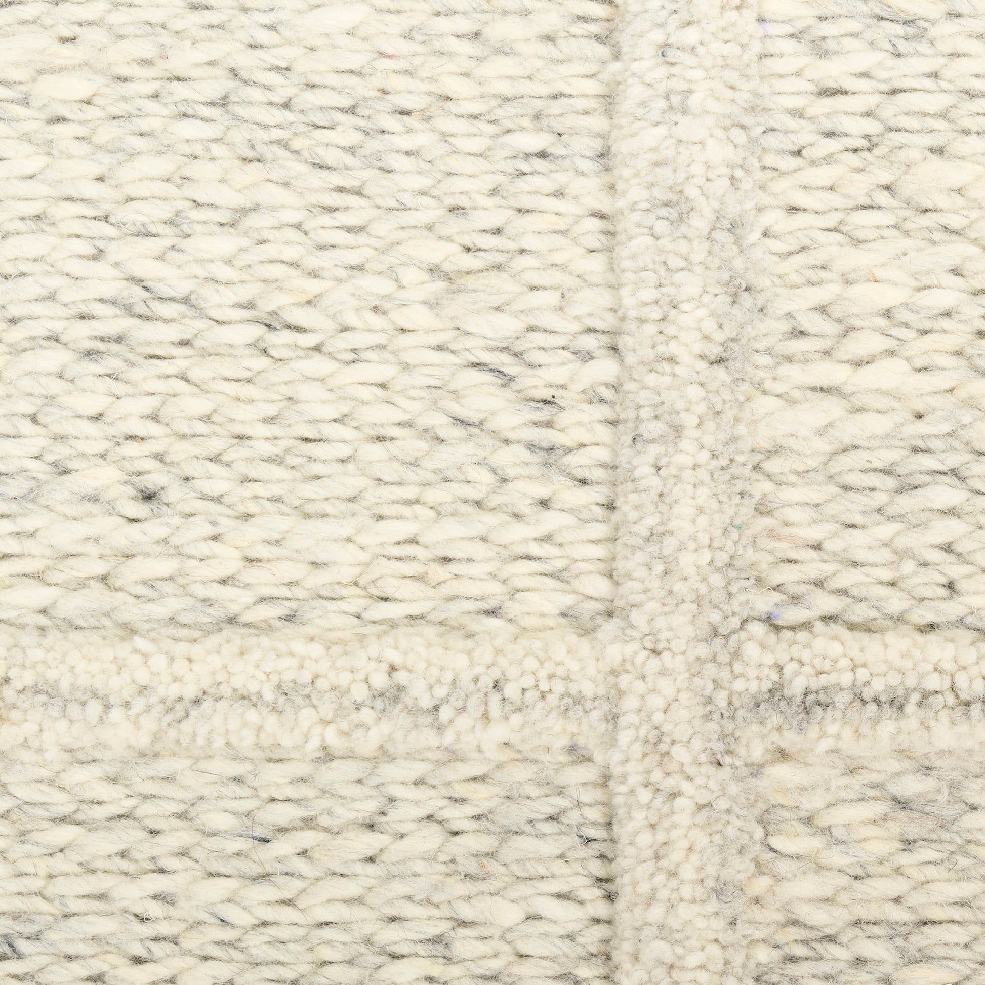 Cream chunky-knit wool blanket with thick woven texture and central seam.