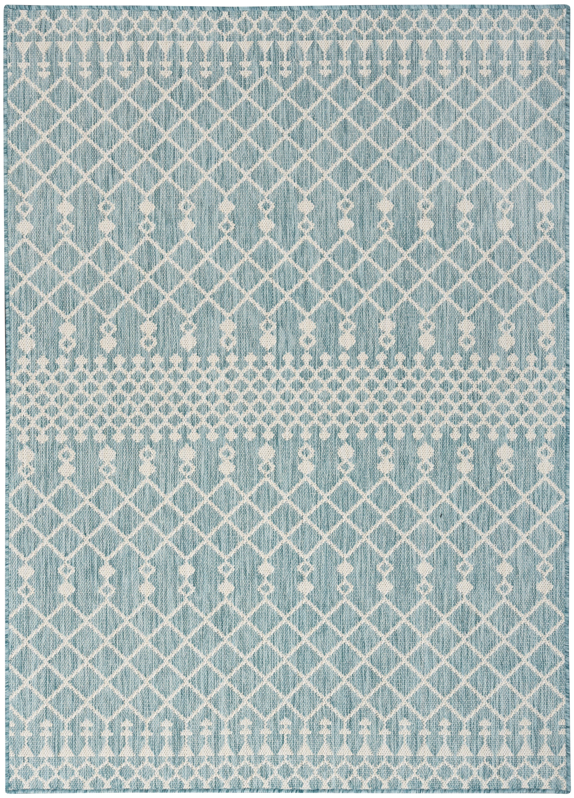 Blue-gray woven rug with white geometric lattice diamonds and dotted horizontal stripes.