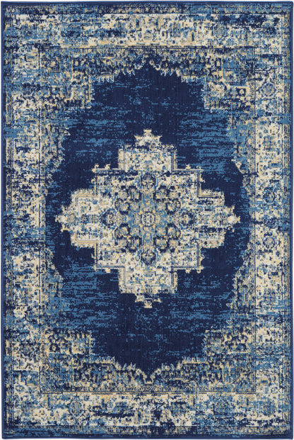 Blue distressed oriental rug with ivory central medallion and ornate navy border in cream and blue tones.