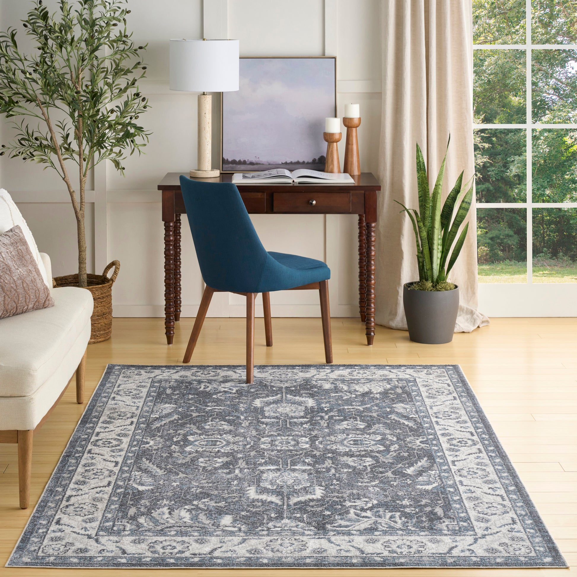 Grey-blue patterned rug in a bright living room.