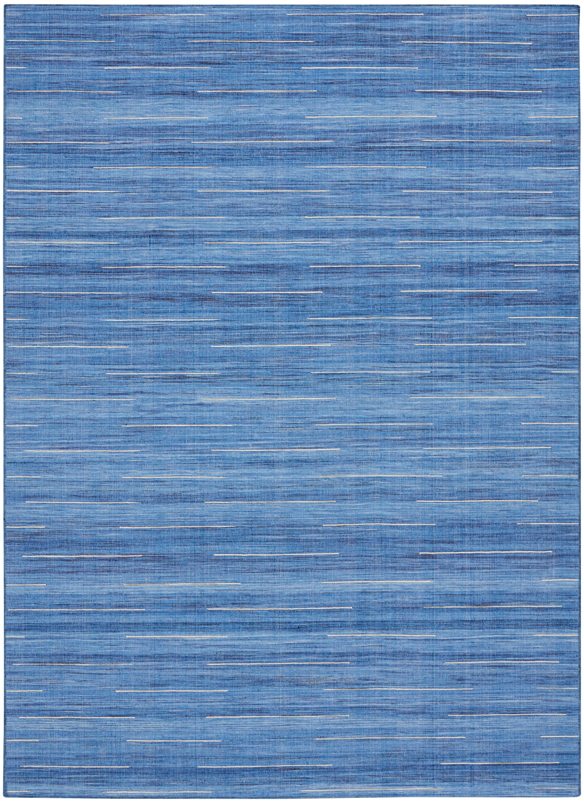 Blue flat-weave rug with random thin white dash lines for a modern coastal look.