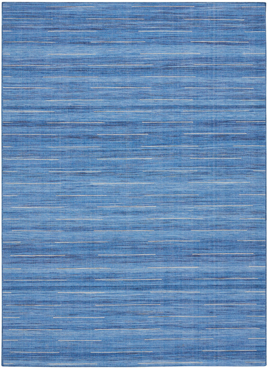 Blue flat-weave rug with random thin white dash lines for a modern coastal look.