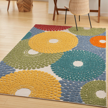 Colorful round-petal rug with large sunburst circles in yellow, teal, orange & green on blue background.