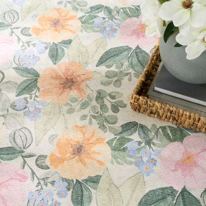 Pastel floral fabric pattern with peach & pink blooms, blue blossoms and green leaves; woven basket with white flowers.