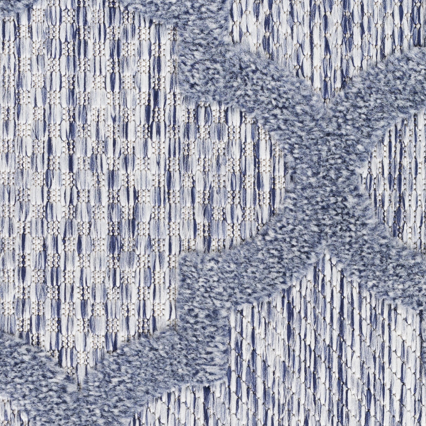 Blue-gray knit fabric with a fluffy chenille X motif over a striped woven background.