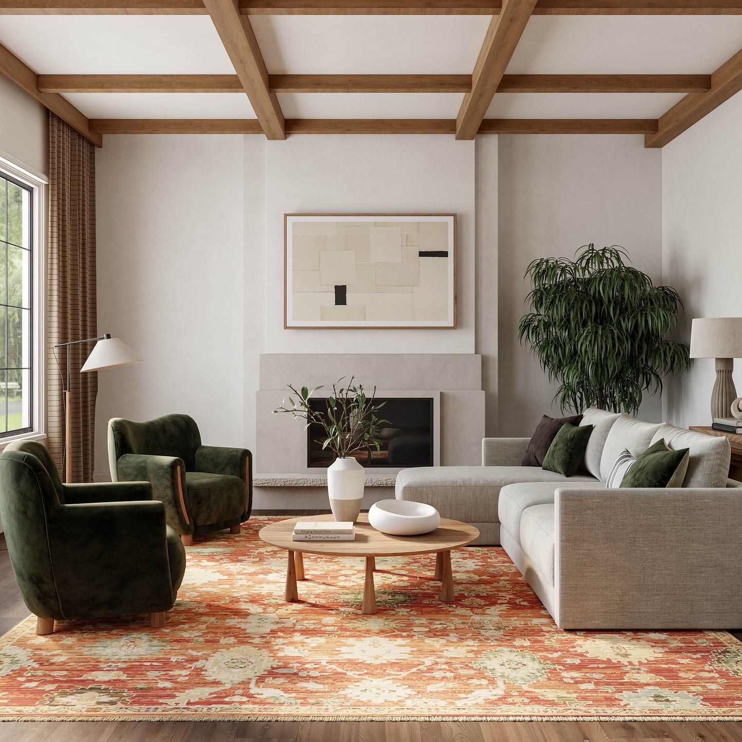 Vintage 6' x 9' orange patterned rug in a living room with a beige sectional sofa, dark green velvet chairs, round wood coffee table, wood-beam ceiling, fireplace and abstract art.