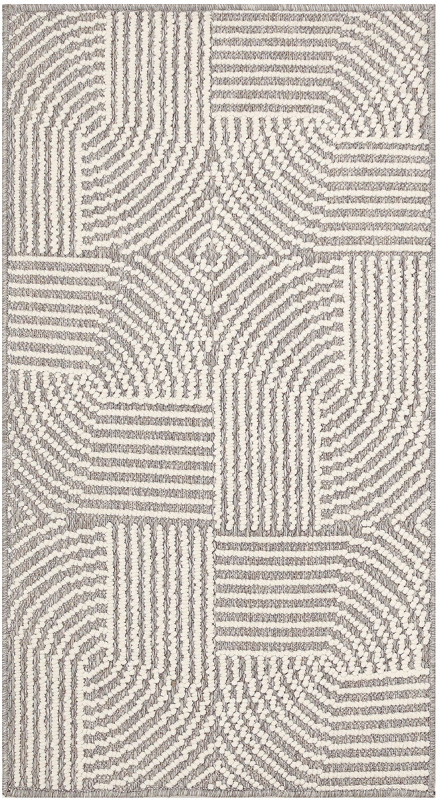 Cream and gray tufted rug with geometric patchwork and radiating line textures.