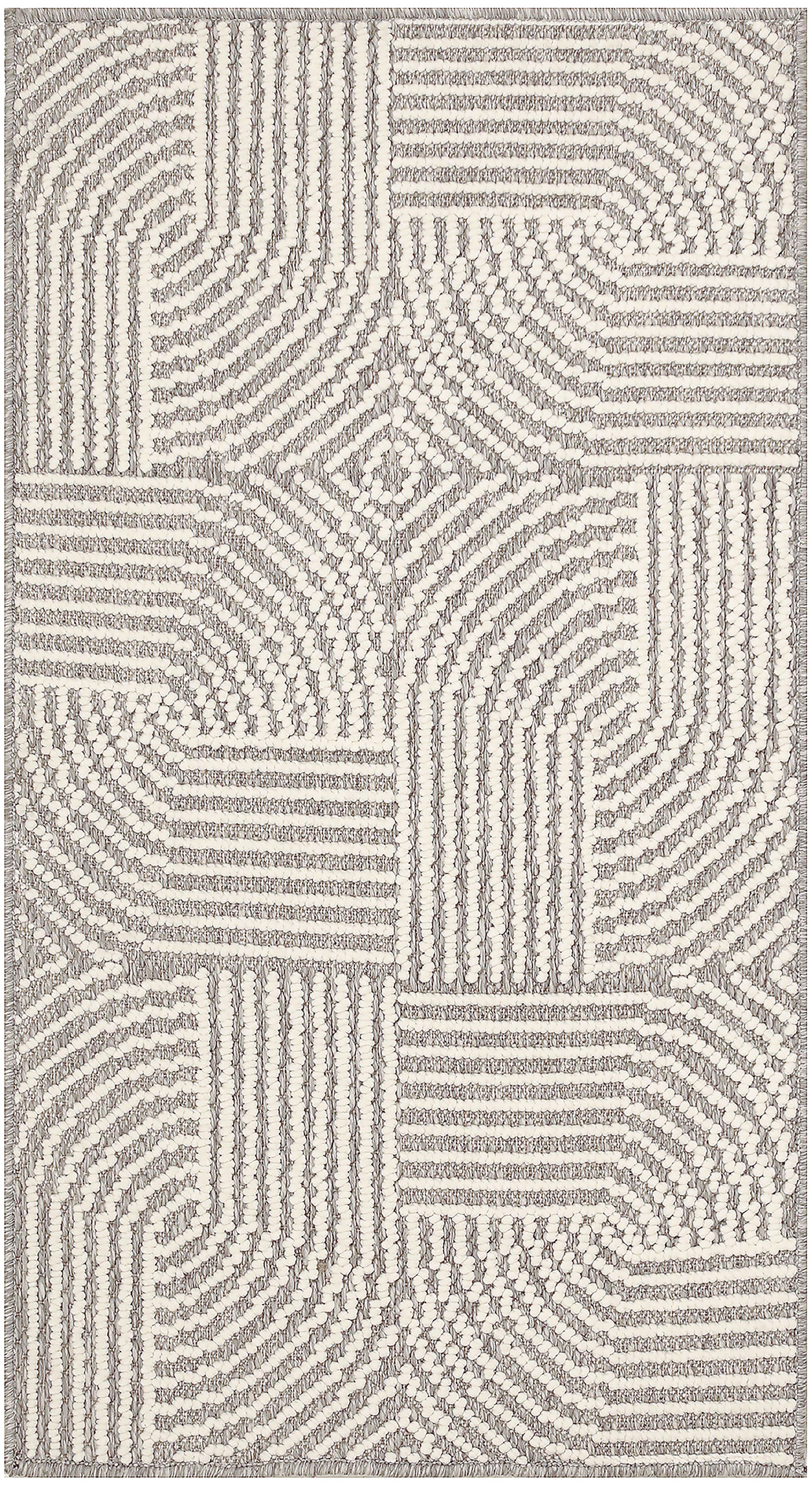 Cream and gray tufted rug with geometric patchwork and radiating line textures.