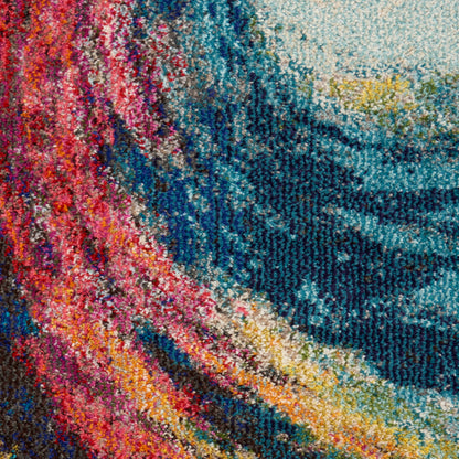 Close-up of a vibrant multicolor knitted textile with pink, orange, yellow, teal and blue swirls.