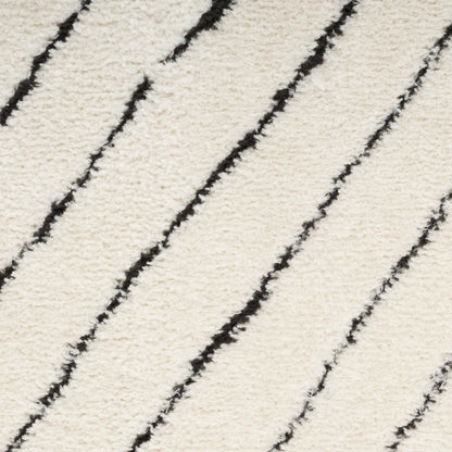 Cream shag rug with bold black diagonal wavy stripes, plush textured surface for contemporary rooms.