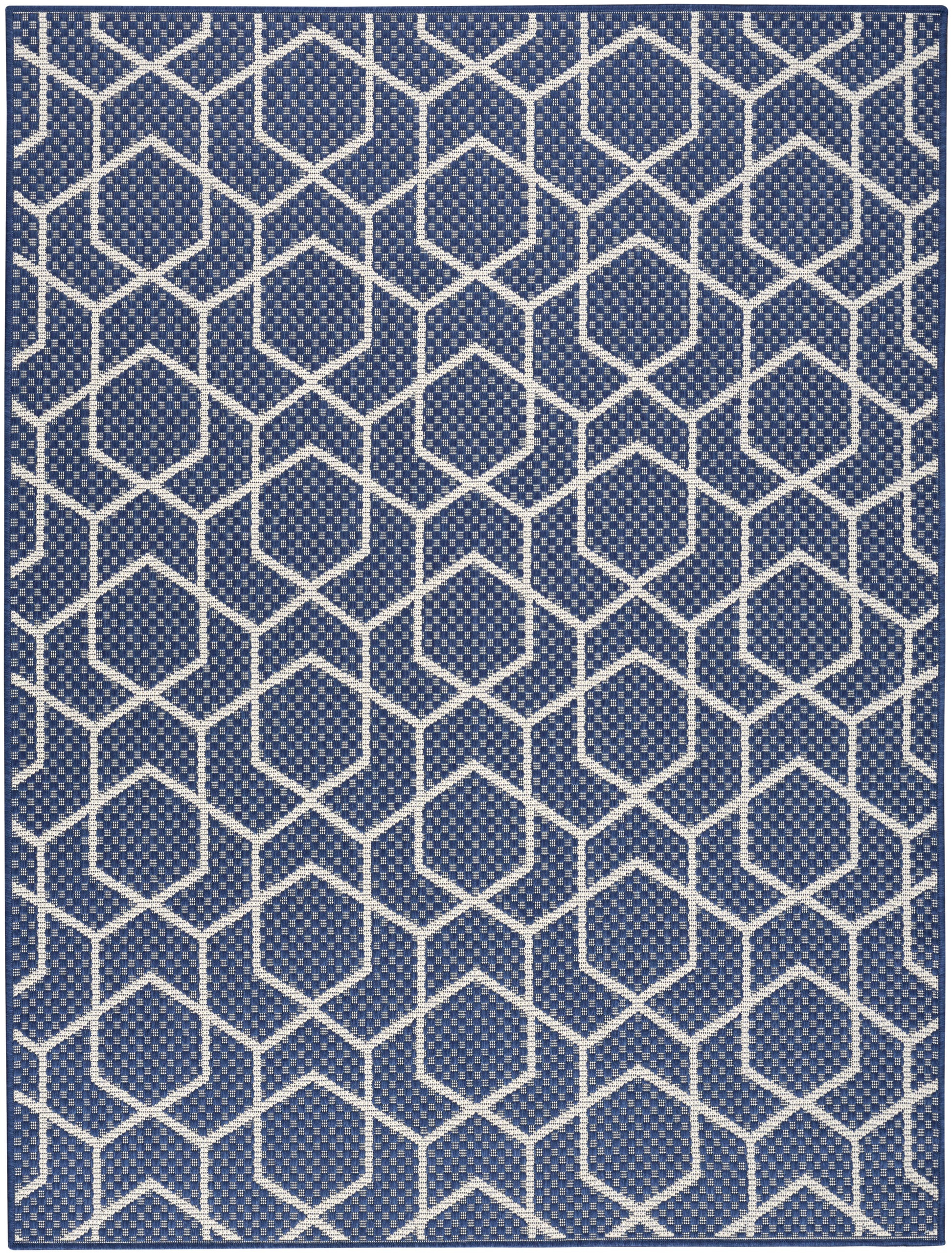 Navy blue rug with white hexagon lattice pattern; geometric woven texture for modern decor.