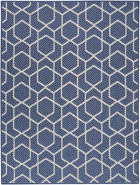 Navy blue rug with white hexagon lattice pattern; geometric woven texture for modern decor.
