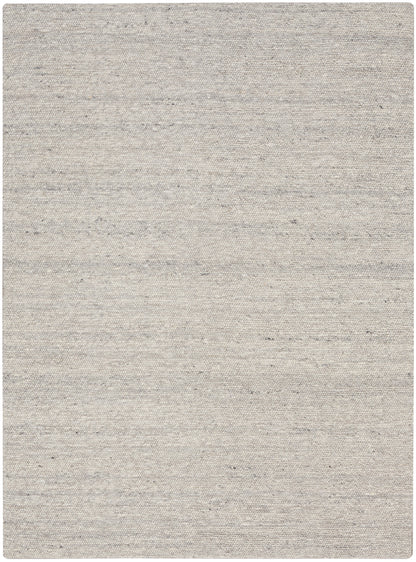 Light gray-beige woven area rug with subtle speckled texture; rectangular, neutral piece for living spaces.