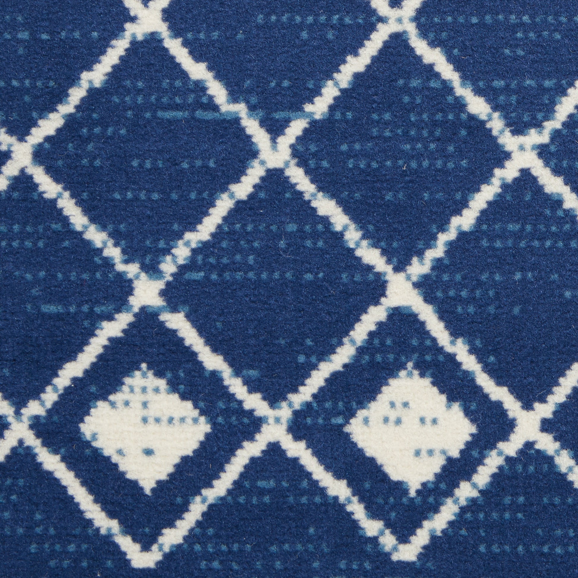Blue woven rug with white diamond lattice and tiny inner diamonds.