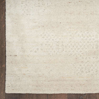 Cream textured rectangular rug with a subtle pattern and a dark brown left border, modern cozy decor.