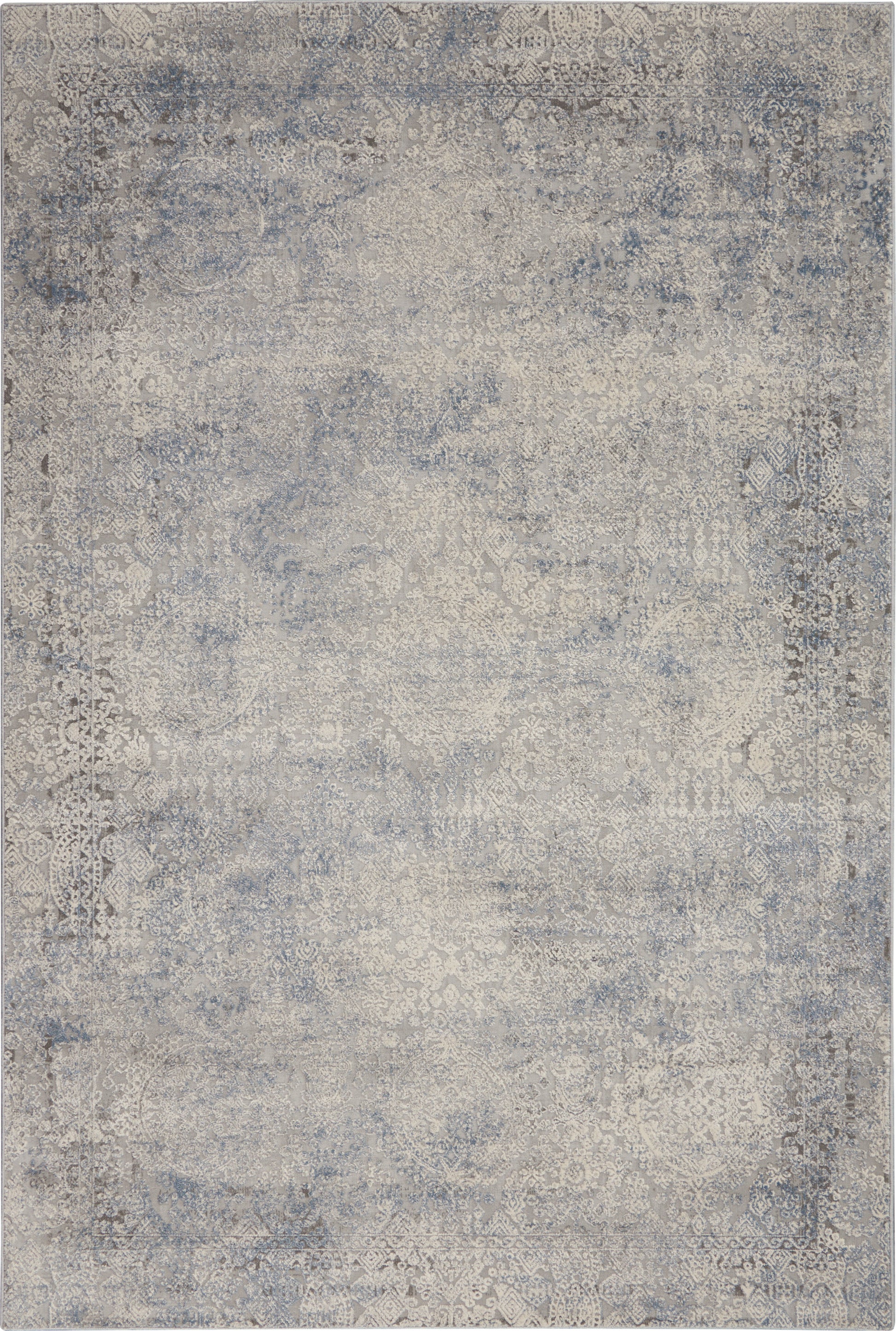 Blue-gray distressed area rug with faded antique medallion patterns in vintage oriental style.
