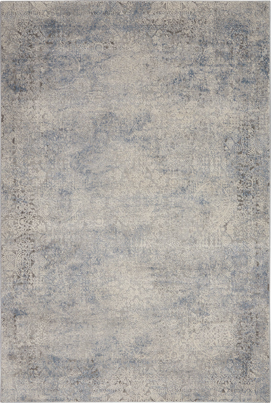 Blue-gray distressed area rug with faded antique medallion patterns in vintage oriental style.
