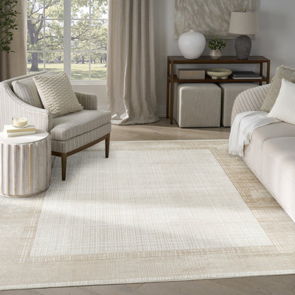 Neutral living room with cream striped armchair, beige sofa, woven bordered rug, wood console and ottomans near a window.