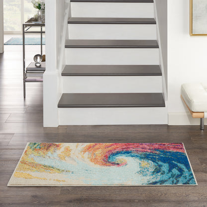 Rectangular area rug with vibrant abstract swirl in orange, yellow, blue and teal, in a modern foyer by the staircase.