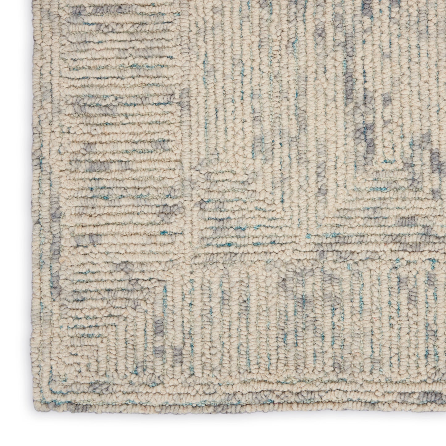 Beige loop-pile rug with pale blue-gray geometric pattern and border.