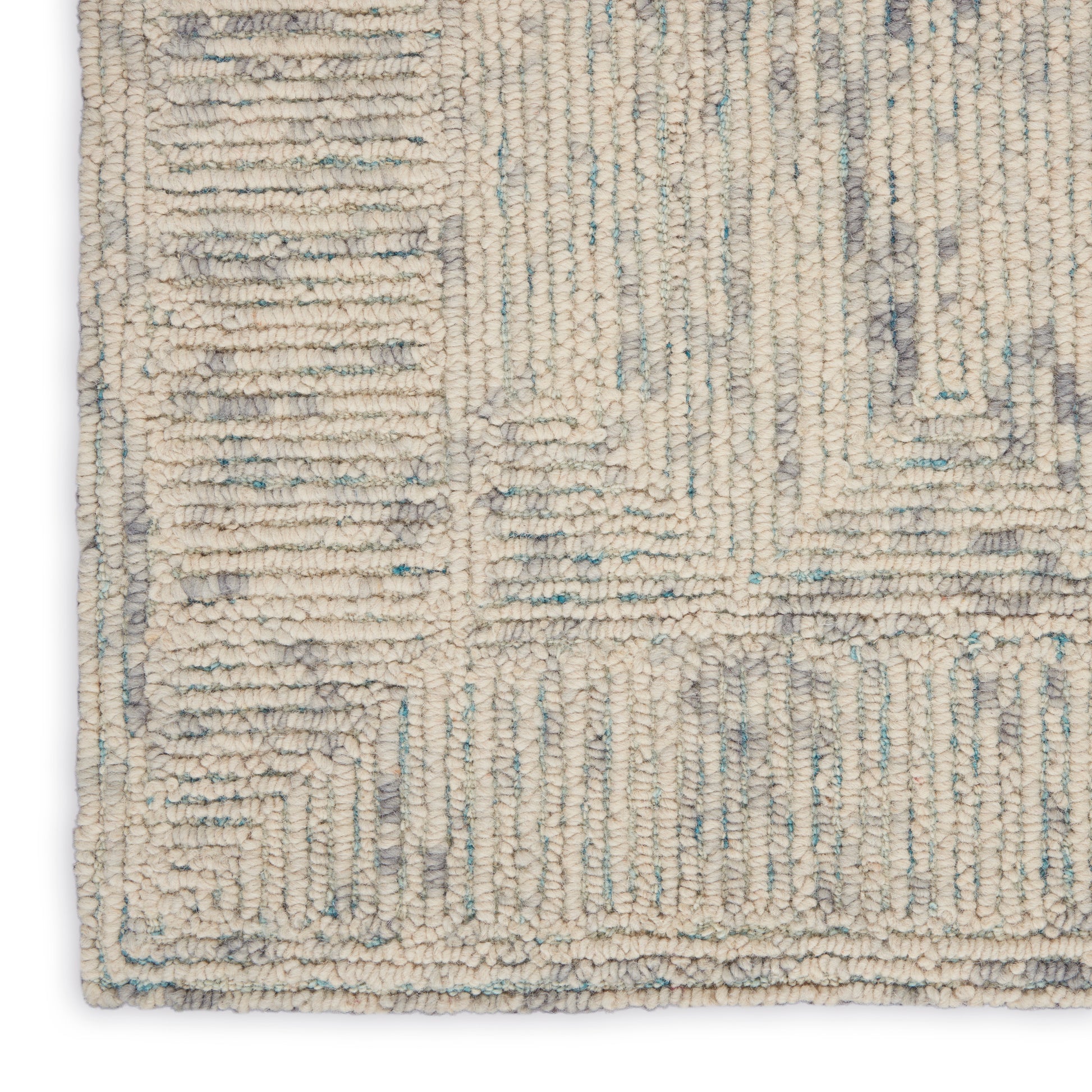 Beige loop-pile rug with pale blue-gray geometric pattern and border.