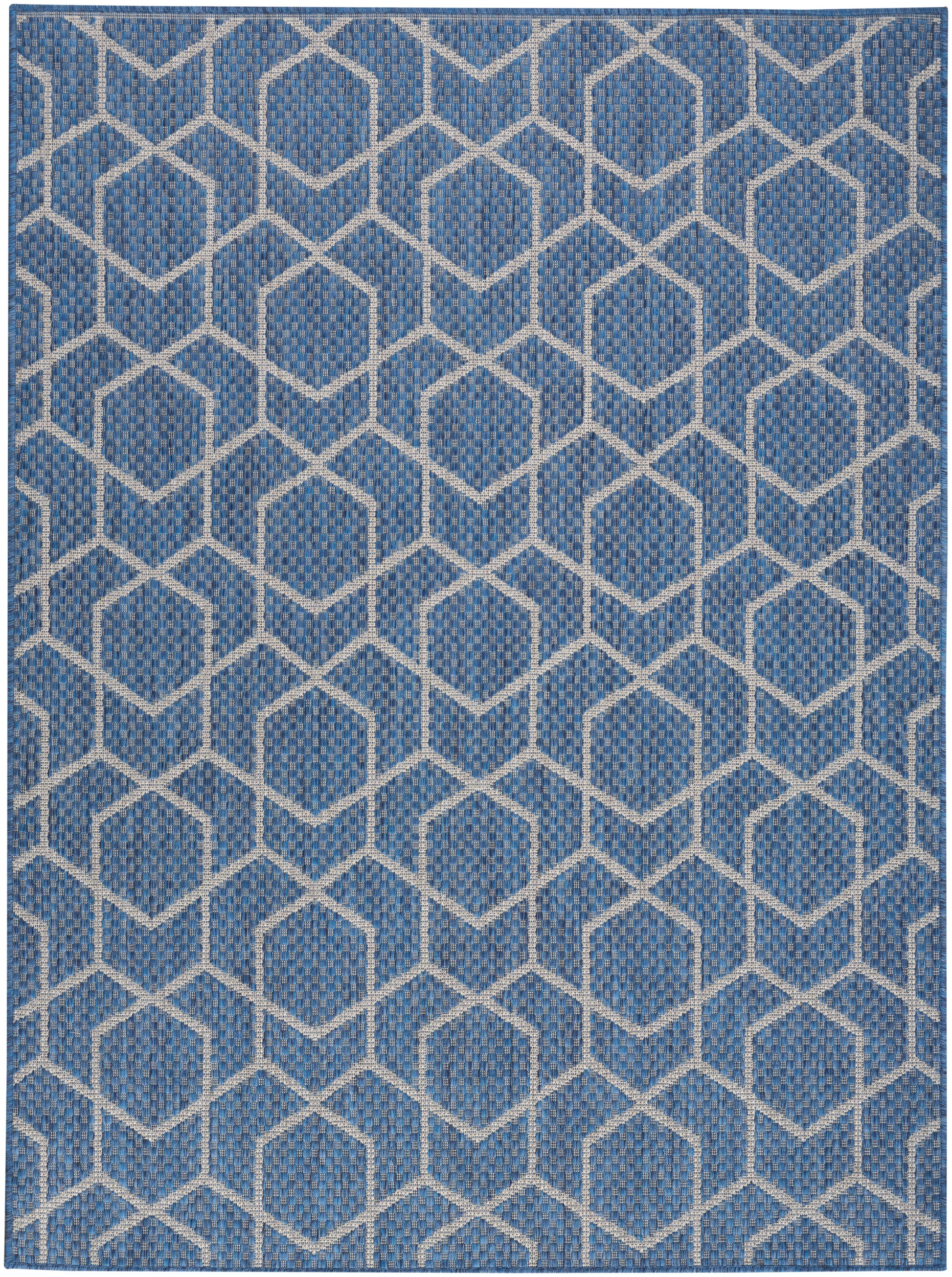 Rectangular blue woven rug with white interlocking hexagon lattice; geometric, modern coastal style.