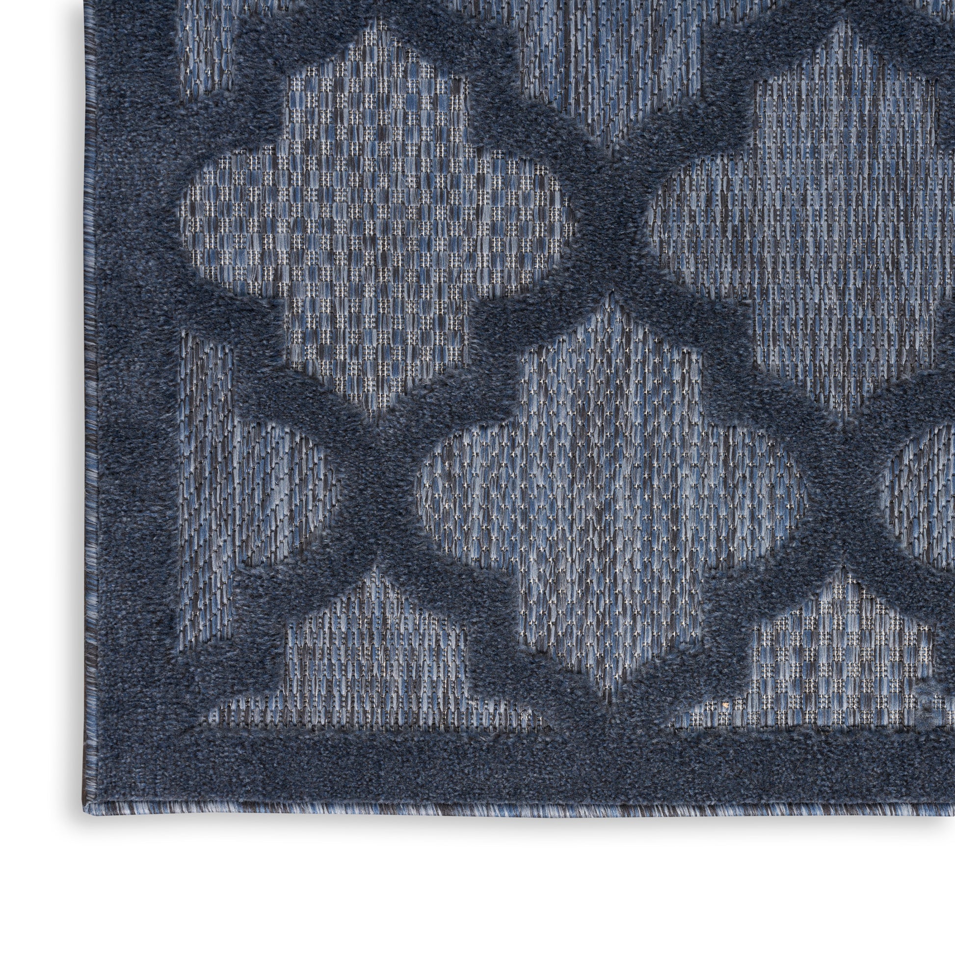 Navy blue woven rug with lighter blue trellis lattice pattern; low-pile rectangle, modern geometric style.