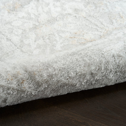 Soft gray shag rug with plush pile on dark wood floor.