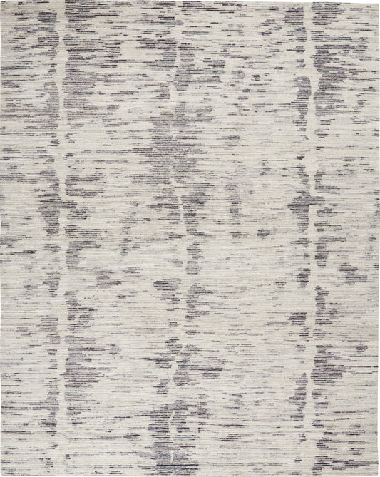 Rectangular area rug with cream base and gray distressed abstract pattern; soft, textured, modern decor.