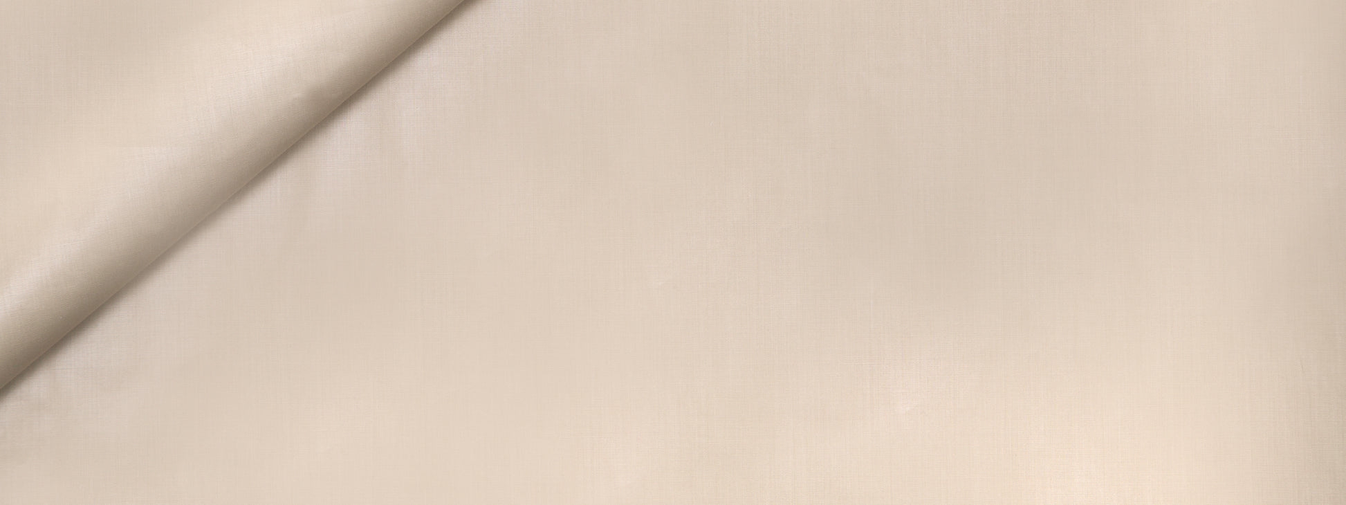 Light beige fabric with a gentle diagonal fold, soft drape suitable for dressmaking or home textiles.