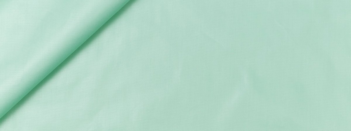 Mint green fabric with a diagonal fold; smooth cotton-like material, suitable for sewing & crafts.