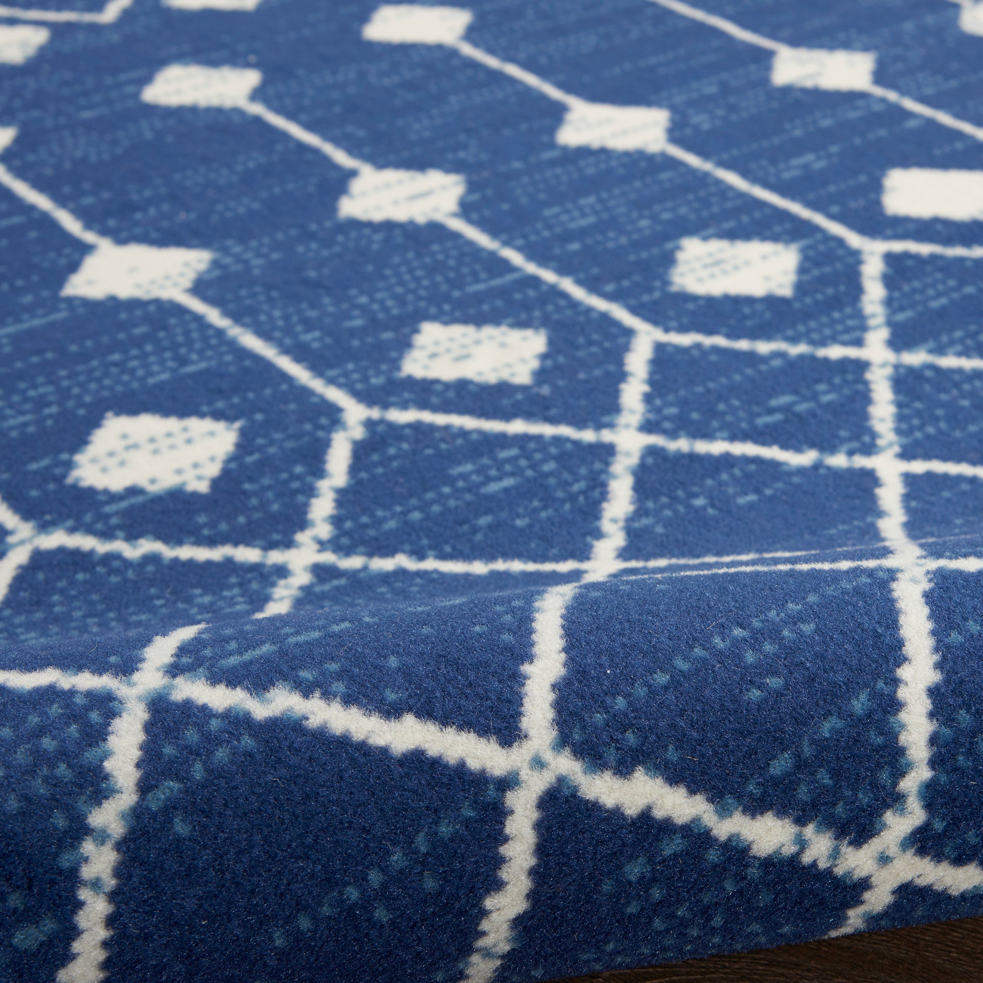 Blue woven rug with white diamond lattice pattern; 4' x 6' rug for cozy home decor.