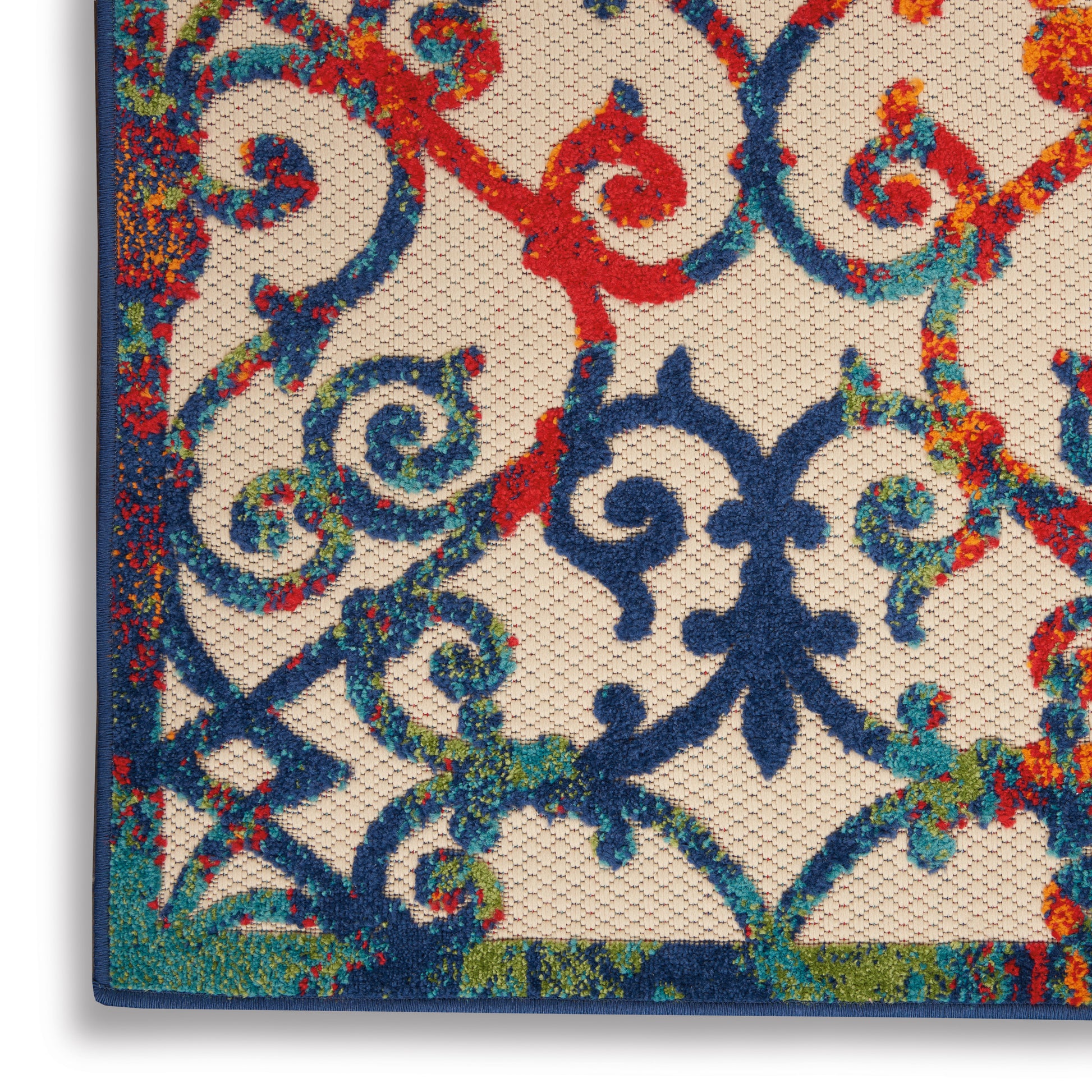 Close-up of vibrant multicolor scrollwork in navy blue, red, turquoise on beige mesh; decorative wrought-iron style wall art.