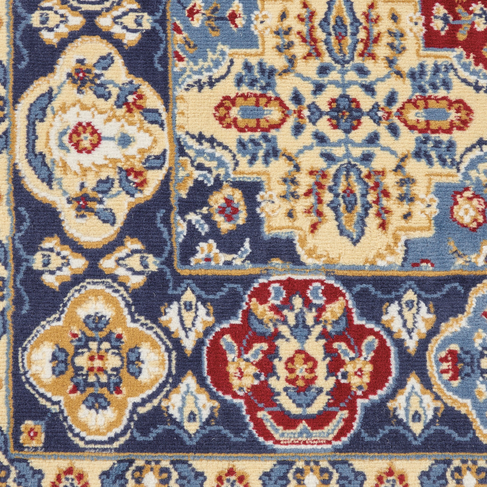 Bohemian-style woven rug with navy, ivory, blue, red and gold floral medallions and decorative border.