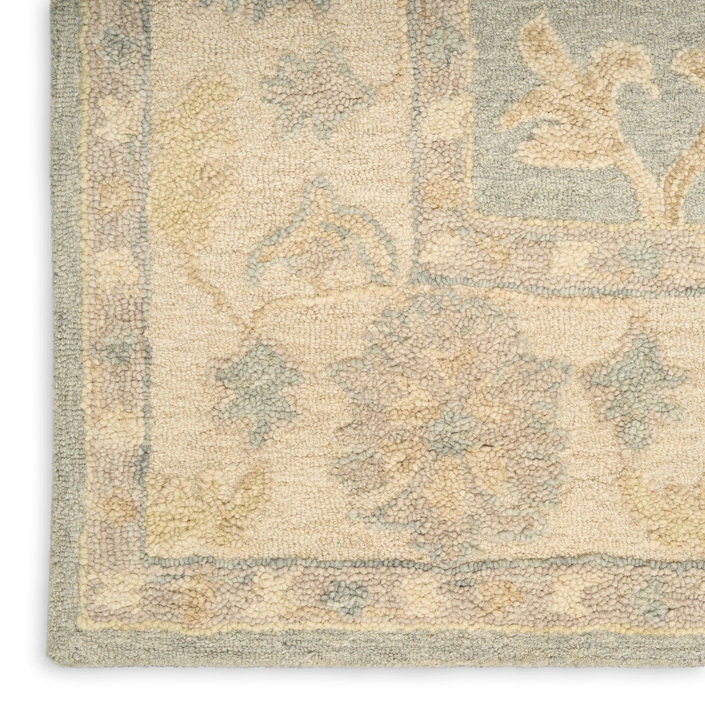 Beige Persian-style area rug with pale blue and yellow motifs; ornate floral border and soft, dense pile.