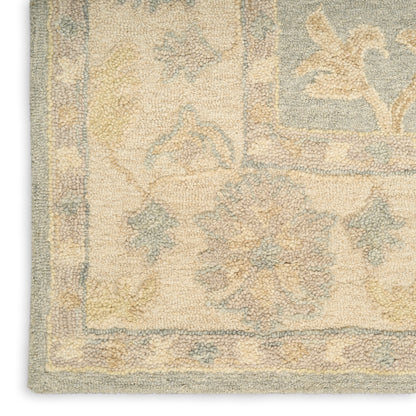 Beige Persian-style area rug with pale blue and yellow motifs; ornate floral border and soft, dense pile.