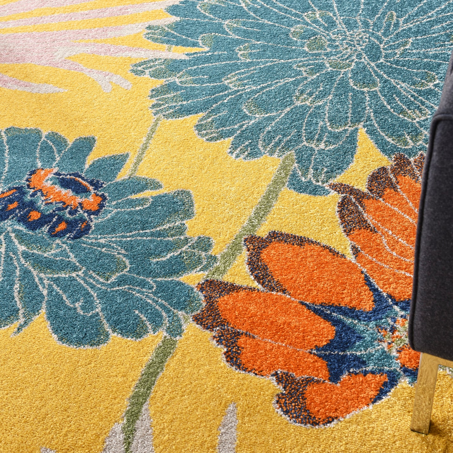Bright floral area rug with teal and orange flowers on yellow background, loop pile for bold decor.