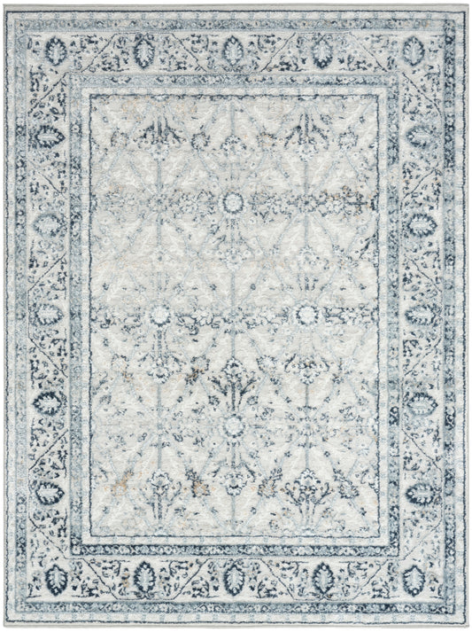 Rectangular grey-blue distressed Oriental rug with antiqued floral motifs and decorative border.