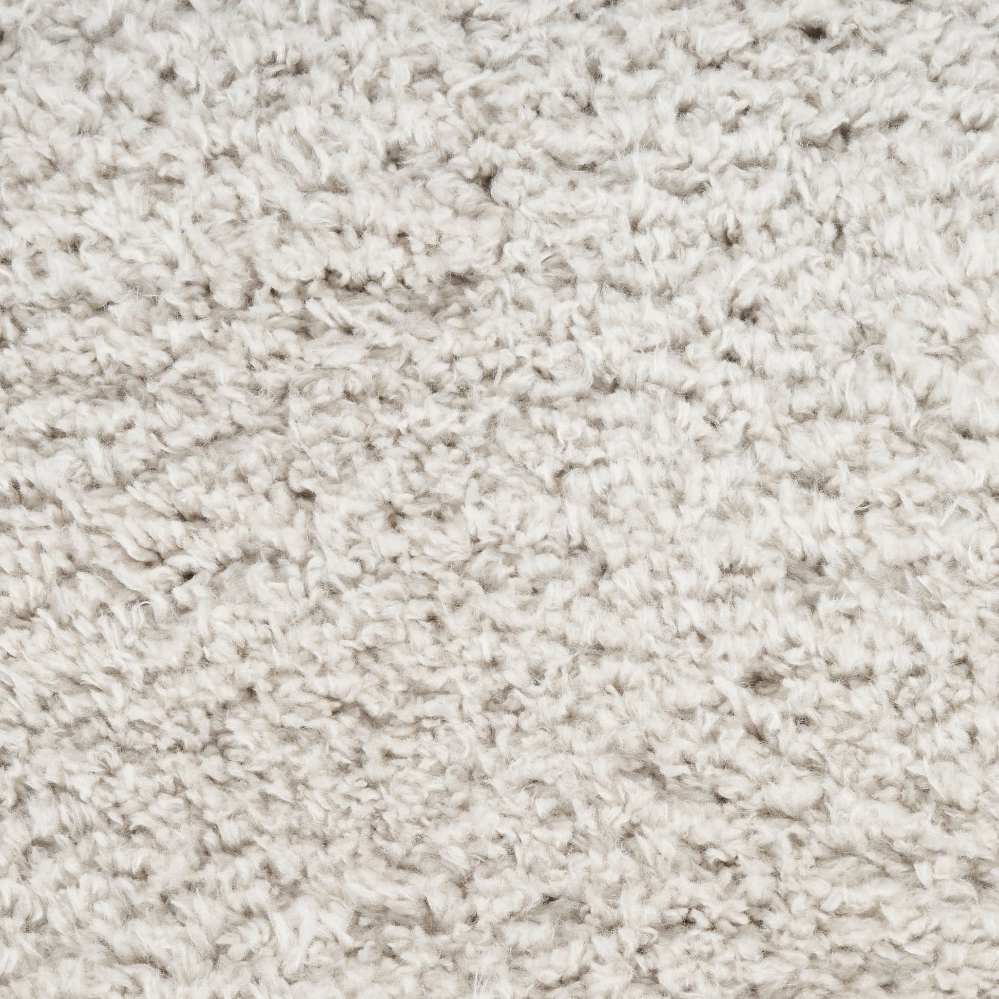Beige fluffy shag rug texture with soft, curly pile close-up.
