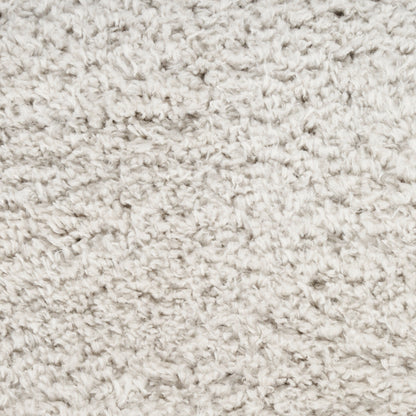 Beige fluffy shag rug texture with soft, curly pile close-up.