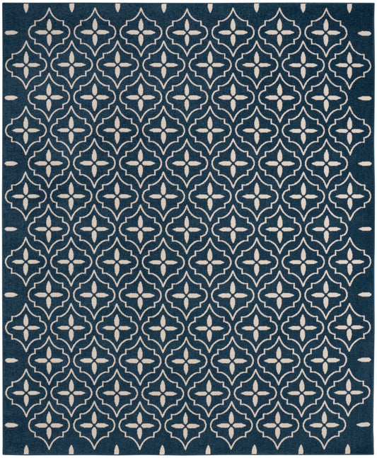 Navy blue rectangular rug with white repeating quatrefoil lattice pattern; modern Moroccan-inspired design.