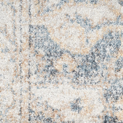 Close-up of a textured beige-blue-gray area rug with soft plush pile and abstract pattern.