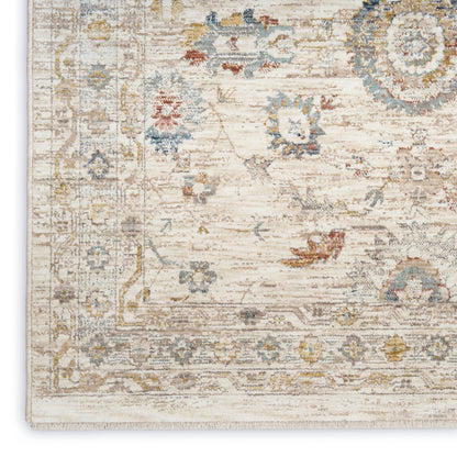 Ivory distressed oriental rug with pale blue, gold & gray floral motifs and decorative border.