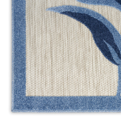 Beige woven area rug with blue border and abstract blue arc design; loop pile, contemporary style.