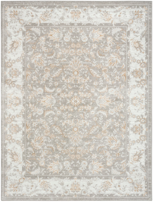 Rectangular grey-blue rug with ivory border and cream-gold floral damask pattern; vintage-inspired living room style.