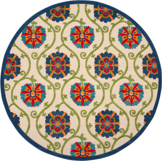 Round rug with cream backdrop, blue edge, teal-green vines and bold red, orange, teal floral medallions.