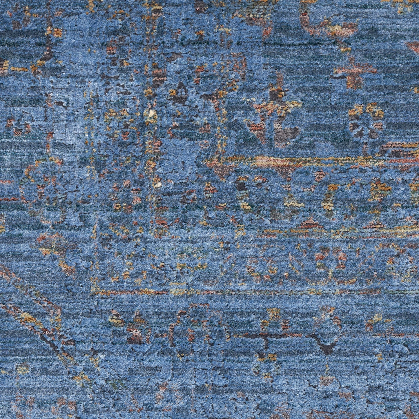 Blue distressed abstract rug with rust and gold accents; soft woven texture for living room decor.