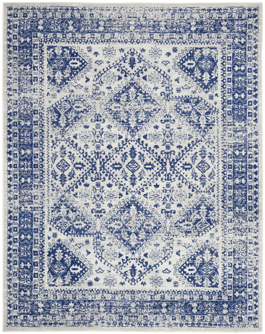 Blue and ivory oriental rug with distressed finish, central diamond medallion and ornate border.