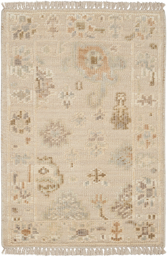 Cream-beige rectangular rug with subtle floral and geometric motifs in pale blue, taupe and tan; fringed ends.